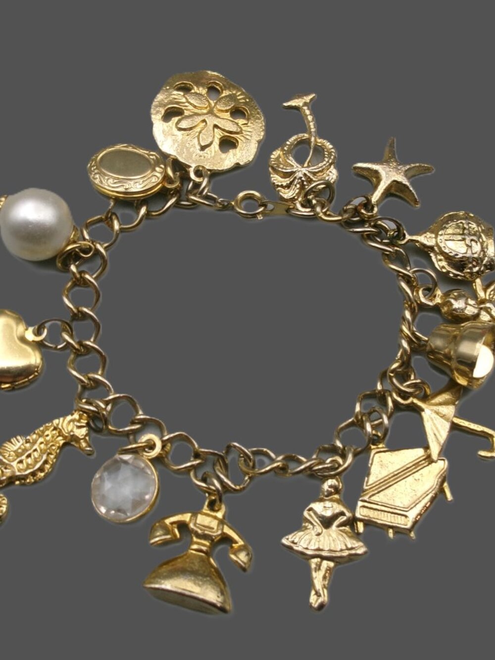 Vtg Gold Tone Full Eclectic Charm Bracelet, Phone, Ballerina, Piano, Cherub etc.